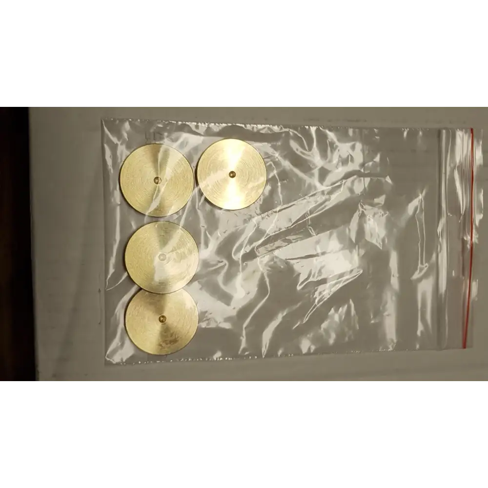 Vier runde Messing-Discs mit Mittelbohrung, in Klarsichtverpackung, ideal als Sound Discs für Gerätefüsse zwischengelegt