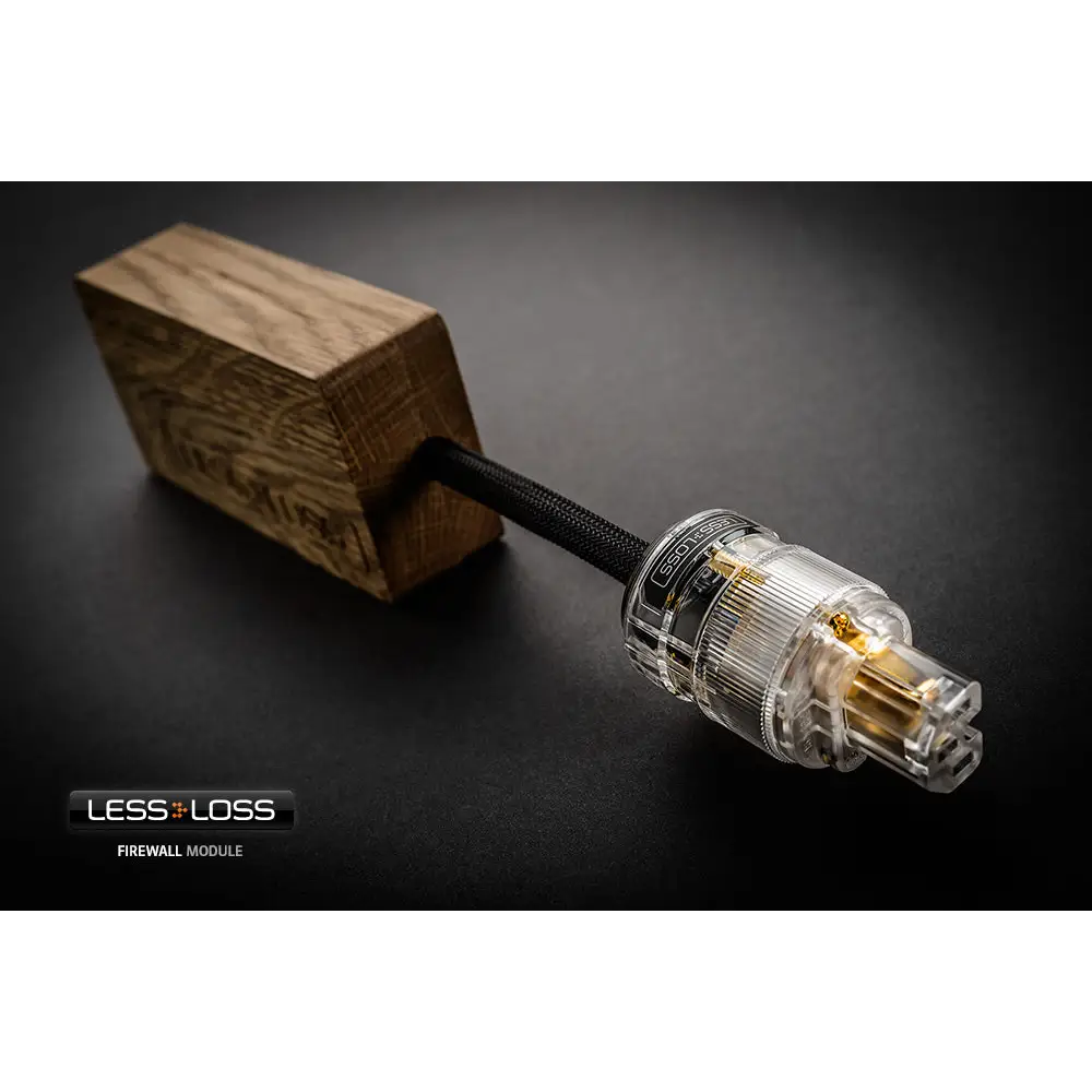 Clear transparent power plug with gold contacts and black braided cable mounted on wood for lessloss firewall 640x netzfilter